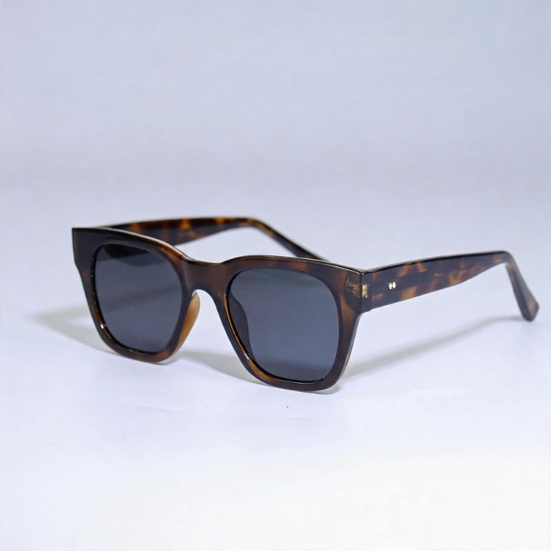 A pair of square Bobotails leopard sunglasses with a classic tortoiseshell pattern in brown and black, featuring dark gray lenses, photographed on a light gray studio background.