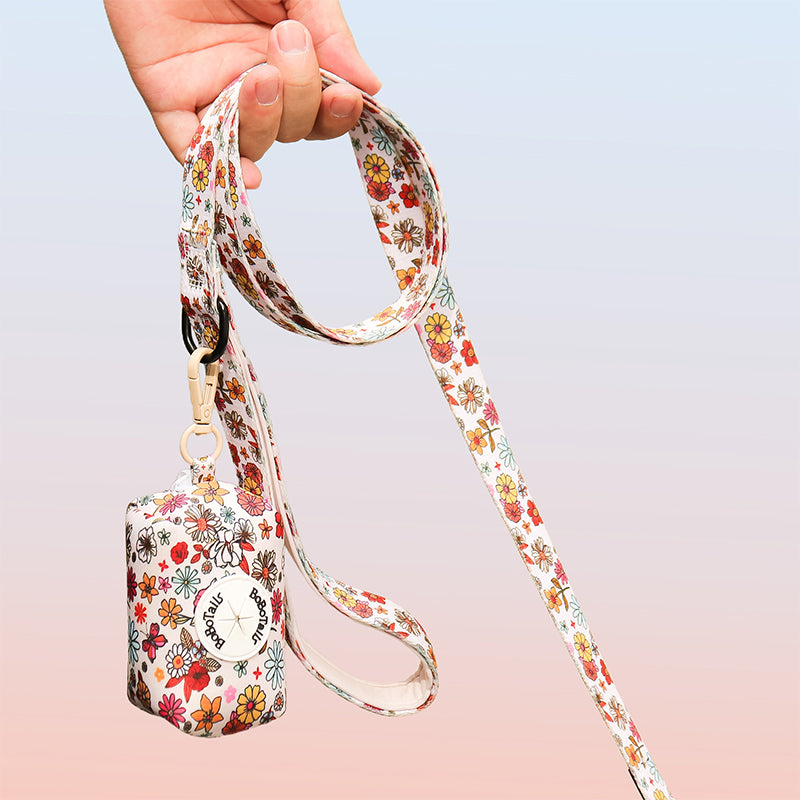 flower printed pet waste bag dispenser matching the harness and owner accessories for daily dog walks